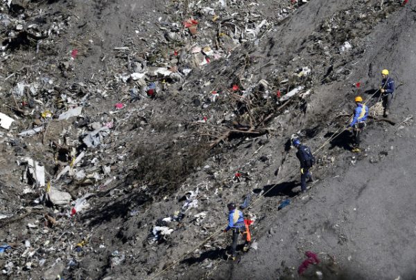 French gendarmes and investigators work amongst the debris of the Airbus A320 at the site of the crash, near Seyne-les-Alpes, French Alps