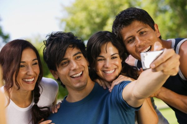 Friends Photographing Themselves --- Image by © moodboard/Corbis