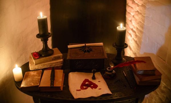 62169278_in-this-picture-taken-oct-9-2016-candles-and-books-are-arranged-on-a-table-before-a-photo-s