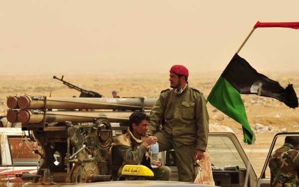 Rebel fighters look out from a vehicle in Ajdabiyah