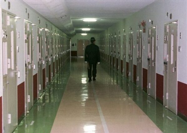 **FILE*A Japanese prison guard patrols the hallway at the Fuchu Prison in Tokyo in this Jan. 24, 1997 file photo. A doctor at a prison in southern Japan regularly abused inmates physically, sparking a riot last month in which several guards were injured, lawyers for the inmates said in Tokyo Tuesday, Dec. 4, 2007. (AP Photo/Katsumi Kasahara, FILE)