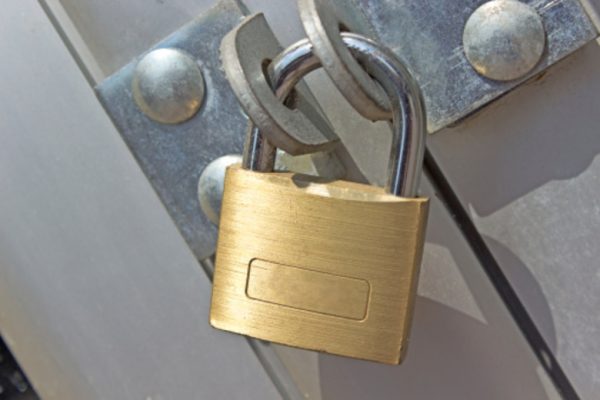 Closed padlock on a metal door