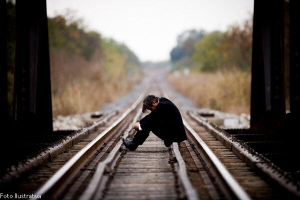 Man Sitting on a Railroad Bridge --- Image by © Richard Schultz/Corbis