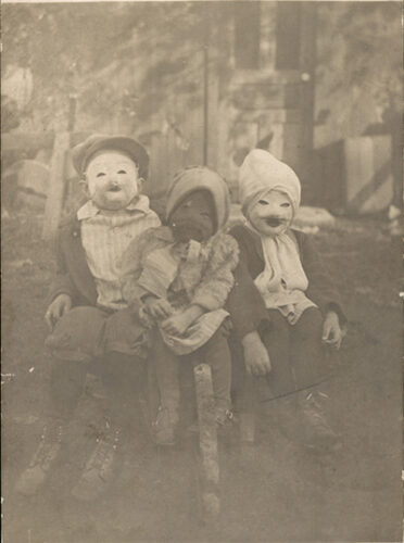 A vintage photo shows children in Halloween masks