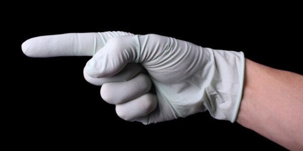 Pointing hand in medical glove
