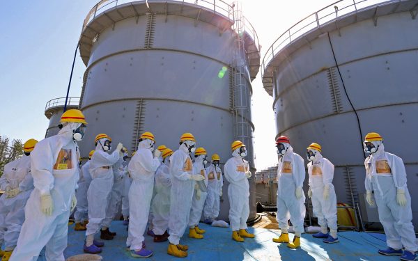 Japanese Prime Minister Shinzo Abe was briefed on the situation at the Fukushima Dai-ichi nuclear power plant as he toured the facility back on Sept. 19, 2013. chief Akira Ono (4th L) in front of two tanks (back) which are being dismantled after leaking contaminated water, during his tour to the tsunami-crippled plant in Okuma, Fukushima Prefecture, northeastern Japan on September 19, 2013. Abe told Fukushima's operator to fix radioactive water leaks as he toured the crippled nuclear plant on September 19, less than two weeks after assuring the world the situation was under control. AFP PHOTO / Japan Pool JAPAN OUT (Photo credit should read JAPAN POOL/AFP/Getty Images)