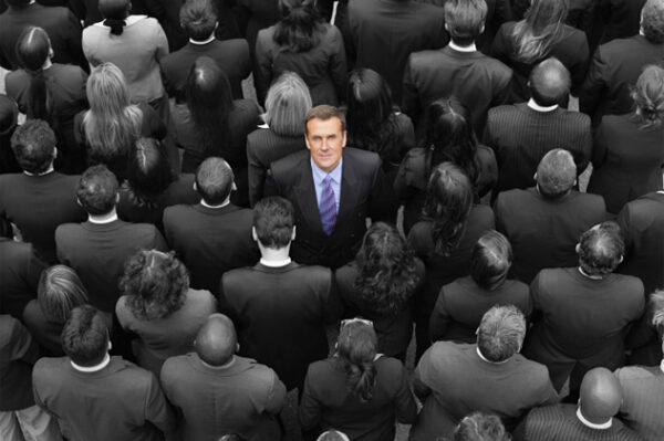 High angle view of a businessman standing amidst businesspeople