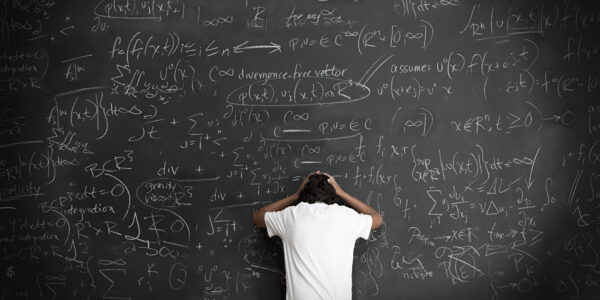 Boy with formulae on blackboard