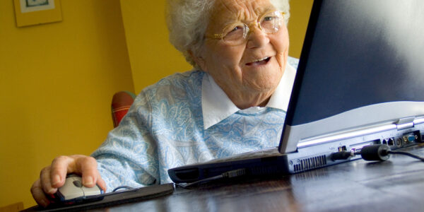 A12TCB Senior elderly lady at home using her new laptop computer and its technology