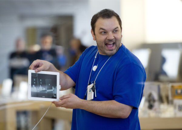 An Apple employee shows an iPad 2 to customers waiting in line outside of the Apple Store's Lincoln Park location on March 11, 2011 in Chicago. Apple's latest gadget went on sale Friday afternoon at all Apple Store locations along with more than 10,000 AT&T, Best Buy, Target, Verizon Wireless, and Walmart retail stores. UPI/Brian Kersey