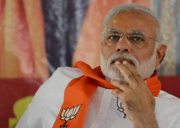 To go with 'India-Election-Modi' by Adam PLOWRIGHT (FILES) In this photograph taken on Aporil 5, 2014, Chief Minister of the western Indian state of Gujarat and Bharatiya Janata Party (BJP) Prime Ministerial Candidate Narendra Modi gestures as he attends a BJP workers gathering in Gandhinagar, some 30kms. from Ahmedabad. To admirers he is a Thatcherite reformer set to jolt India from the economic doldrums, while his opponents liken him to Putin or even Hitler. Indian election frontrunner Narendra Modi divides opinion like few other politicians. The rise of one of India's most polarising public figures even split his own party, where worries about his controversial past and abrasive personality meant he had to overcome heavy internal dissent. AFP PHOTO/Sam PANTHAKY/FILES