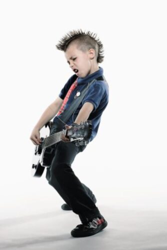 Boy (8-10) playing guitar