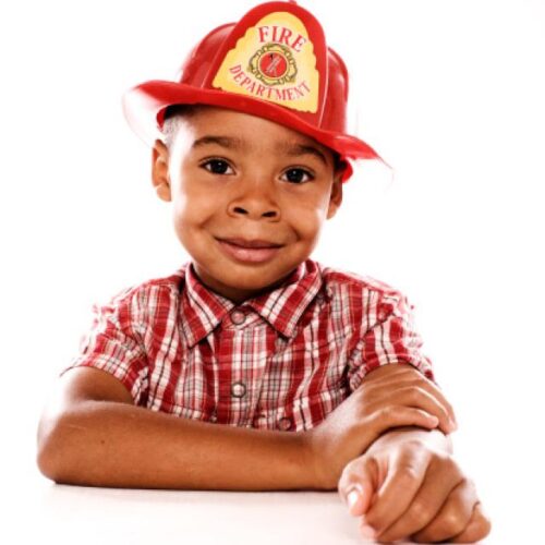 young boy wearing fireman hat