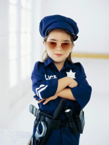 Portrait of a girl wearing sunglasses and pretending to be a policewoman