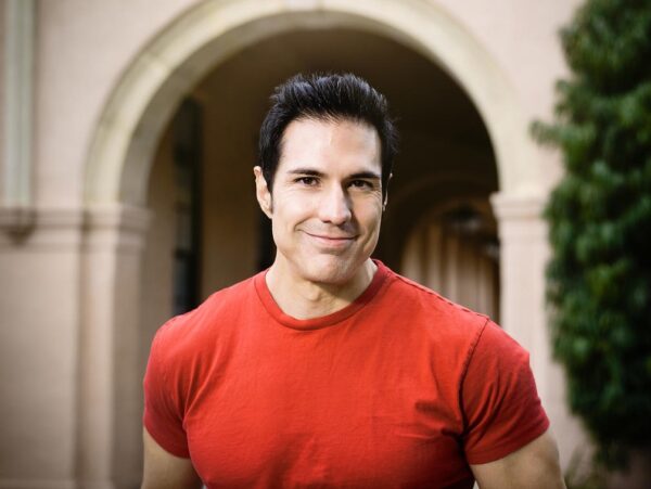 Portrait of a muscular man wearing a red t-shirt.