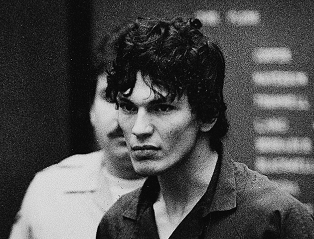 Richard Ramirez, accused of 14 counts of murder in the "Night Stalker" serial killings, is flanked by attorneys Daniel Hernandez, left, and Arturo Hernandez during court appearance in Los Angeles, Ca., Tuesday, Oct. 21, 1985. Ramirez wants the two men to represent him instead of his current attorney, Joseph Gallegos. Municipal Court Judge Elva Soper advised Ramirez to refrain from making a hasty second change of defense attorneys. (AP Photo/Lennox McLendon)