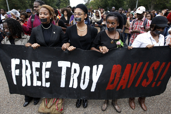 Demonstrators gather in front of the White House in Washington as they hold a vigil before the scheduled execution of death row inmate Troy Davis, Wednesday, Sept. 21, 2011. Davis is facing lethal injection for killing an off-duty Georgia policeman in Savannah, a crime he and others have insisted for years that he did not commit. (AP Photo/Charles Dharapak)