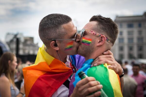 LONDON, ENGLAND - JUNE 27:  A couple kiss in Trafalgar Square after the annual Pride in London Parade on June 27, 2015 in London, England.  Pride in London is one of the world's biggest LGBT+ celebrations as thousands of people take part in a parade and attend performances at various locations across the city. (Photo by Rob Stothard/Getty Images)