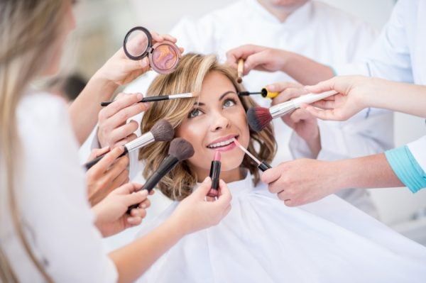 Beautiful woman getting a makeup transformation at the beauty salon