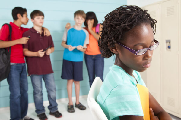 Getty Creative Stock image for Bullying Teens using wireless technology at school to bully classmate