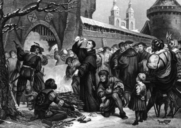 Circa 1518, Martin Luther standing before a fire with the work of Johann Tetzel in his hand. Tetzel and Luther wrote theological works arguing with the other's cause, resulting in the public burning of each other's work. Original Artwork: Engraved by Chevalier after (Photo by Hulton Archive/Getty Images)