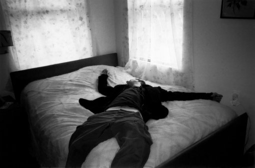 Man lying on bed (B&W)
