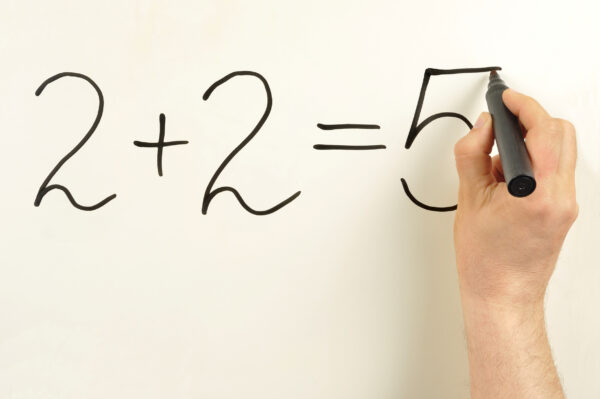2+2=5 formula written on a board