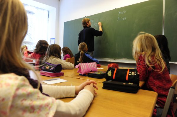 A teacher writes on the blackboard during class in a primary school in Berlin December 7, 2010. The three-yearly OECD Programme for International Student Assessment (PISA) report, which compares the knowledge and skills of 15-year-olds in 70 countries around the world, ranked Germany in the middle field for reading skills and above the OECD-average for mathematics and natural sciences. Teenagers from the Chinese city of Shanghai have the best education in the world, according to the major international study.       AFP PHOTO / JOHN MACDOUGALL (Photo credit should read JOHN MACDOUGALL/AFP/Getty Images)