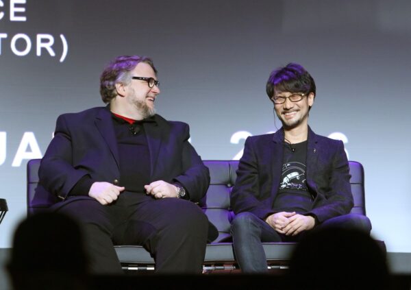 Guillermo del Toro, left, film director at DelToro Films and Hideo Kojima, game designer at Kojima Productions, share a laugh while participating in a panel discussion at the D.I.C.E. Summit Thursday, Feb. 18, 2016, in Las Vegas. (AP Photo/Ronda Churchill)