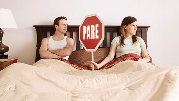 Couple_holding_stop_sign_in_bed