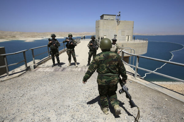 Peshmerga fighters stand guard at Mosul Dam in northern Iraq August 21, 2014. Despite its structural faults, the country's biggest dam at 3.6 km long, built by a German-Italian consortium in the 1980s, is a vital water and power source for Mosul, Iraq's largest northern city of 1.7 million residents. Control the dam and you control the 'keys' to the city. With that in mind, Islamic State insurgents who captured swathes of Iraq and Syria and declared a caliphate, wrested control of the dam from Kurdish forces in recent weeks. While Iraqi and Kurdish forces recaptured the dam with the help of U.S. air strikes on Monday, "the most dangerous dam in the world" - as a U.S. Army Corps of Engineers report described it - still has the potential for catastrophe.   REUTERS/Youssef Boudlal (IRAQ - Tags: CIVIL UNREST POLITICS MILITARY) - RTR437N2