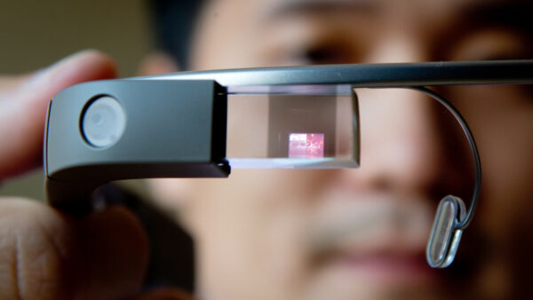 Software developer Brian Ho holds a Google Glass device at Vandrico, a Canadian company specializing in wearable computing, during a demonstration for the media in North Vancouver, B.C., on Tuesday July 30, 2013. The company is developing software for the device which is one of only a few in the country. (AP Photo/The Canadian Press, Darryl Dyck)
