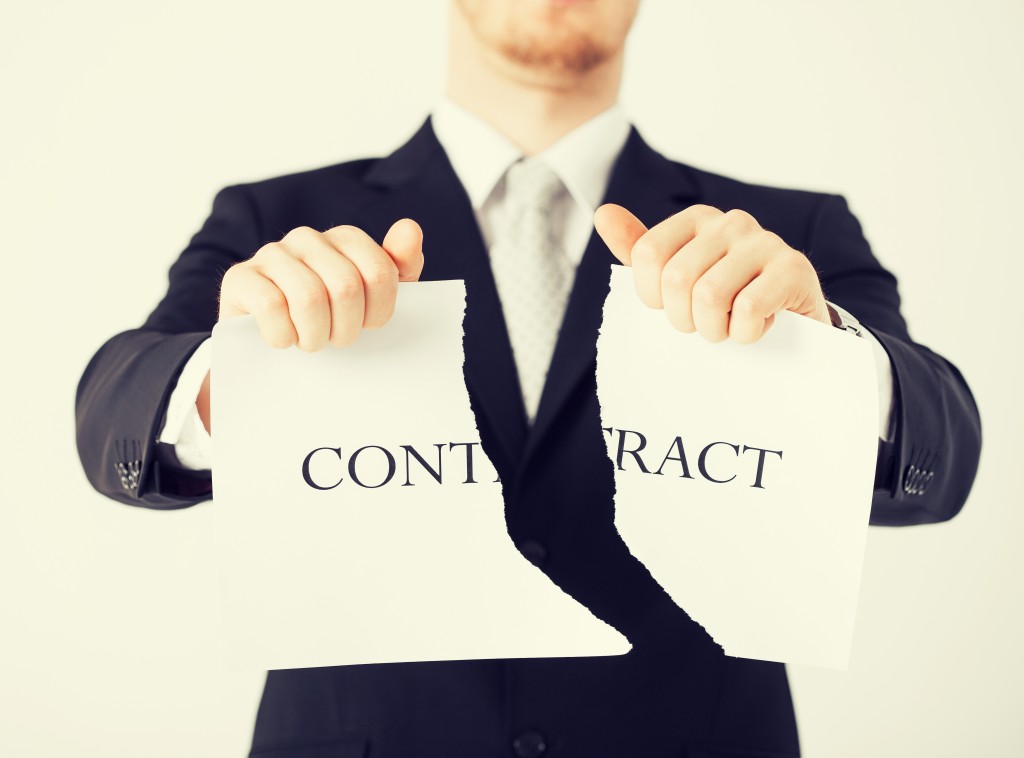 picture of man hands tearing contract paper