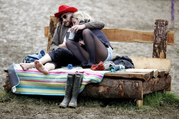 A couple relax togethr in The Park area of the Glastonbury Festival on Saturday 28th June 2014. Day two of the festivals highlights this year include Lana del Ray, Jack White and Metallica. Photograph by Mary Turner.