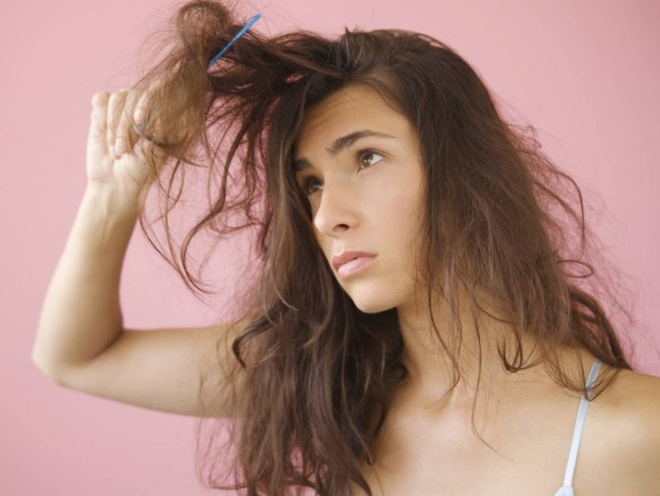 Woman combing knotted hair