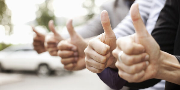 Human hands showing thumbs up sign