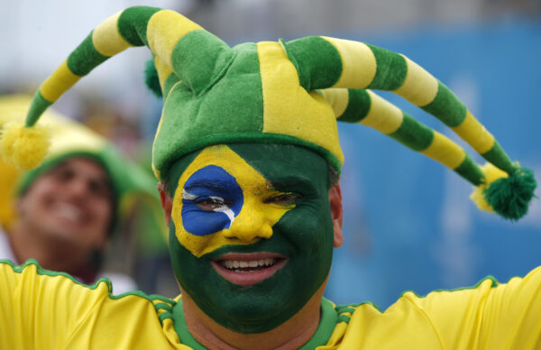 A Brazilian fan wears his nation's flag as face paint before the group A World Cup soccer match between Brazil and Mexico at the Arena Castelao in Fortaleza, Brazil, Tuesday, June 17, 2014. (AP Photo/Eduardo Verdugo)