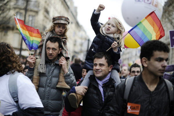 Two men holding their daughter on their shoulder take part in a demonstration for the legalisation of gay marriage and LGBT (lesbian, gay, bisexual, and transgender) parenting, in Paris on December 16, 2012 . AFP PHOTO / LIONEL BONAVENTURE (Photo credit should read LIONEL BONAVENTURE/AFP/Getty Images)