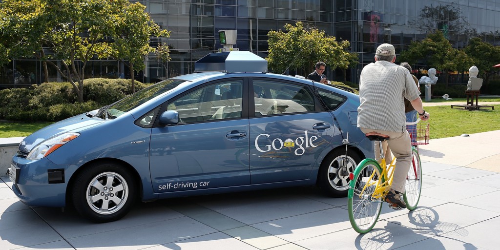 MOUNTAIN VIEW, CA - SEPTEMBER 25:  A bicyclist rides by a Google self-driving car at the Google headquarters on September 25, 2012 in Mountain View, California.  California Gov. Jerry Brown signed State Senate Bill 1298 that allows driverless cars to operate on public roads for testing purposes. The bill also calls for the Department of Motor Vehicles to adopt regulations that govern licensing, bonding, testing and operation of the driverless vehicles before January 2015.  (Photo by Justin Sullivan/Getty Images)