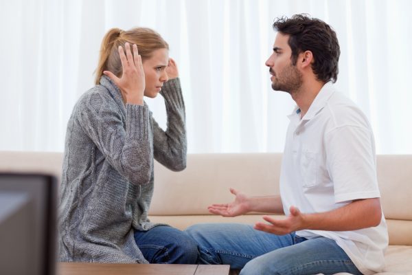 Young couple arguing in their living room