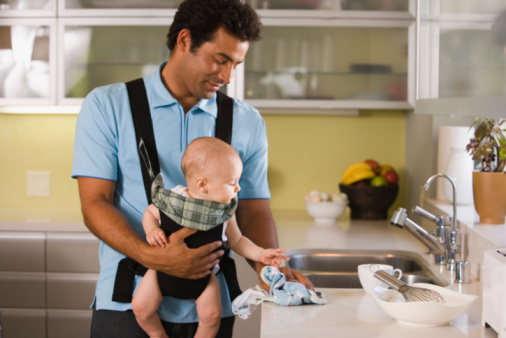 Father with baby in a baby carrier