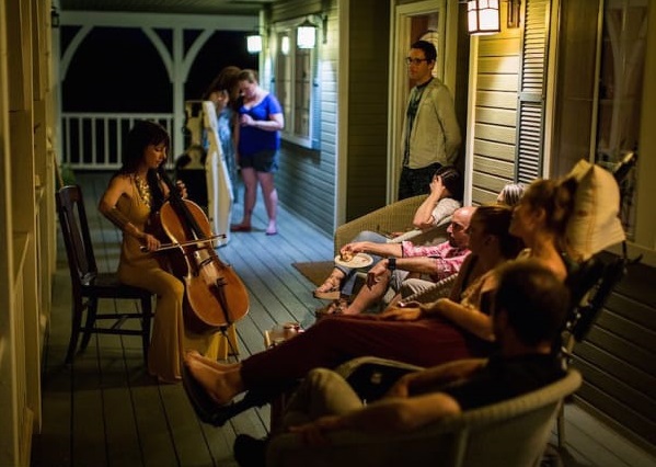 This July 23, 2016 photo provided by Niels Alpert, Kestrin Pantera plays her chello at a going away party for her friend Betsy Davis in Ojai, Calif. In early July, Davis emailed her closest friends and family to invite them to a two-day celebration, telling them: "These circumstances are unlike any party you have attended before, requiring emotional stamina, centeredness, and openness.  And one rule: No crying."  The 41-year-old woman diagnosed with ALS,  held the party to say goodbye before becoming one of the first California residents to take life-ending drugs under a new law that gave such an option to the terminally ill. (Niels Alpert via AP)