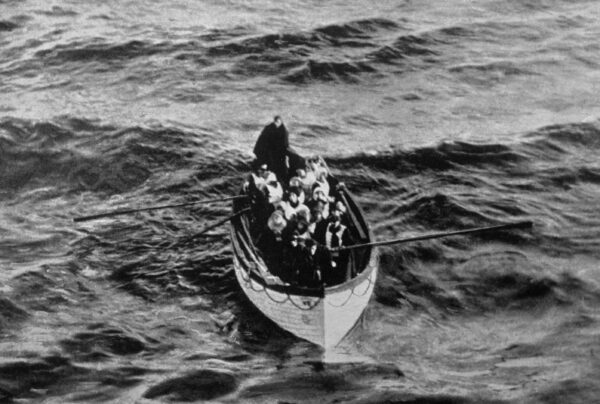 15 Apr 1912 --- An emergency cutter lifeboat carrying a few survivors from the , seen floating near the rescue ship on the morning of April 15, hours after the disaster. did not carry enough lifeboats to save all her passengers, and many of the available boats were launched carrying fewer than their 65-passenger capacity. --- Image by © Ralph White/CORBIS