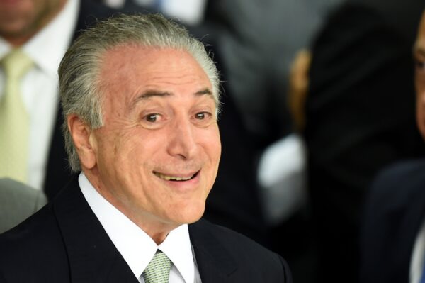CORRECTION - Brazilian acting President Michel Temer (R) gestures during the inauguration ceremony of the new ministers at Planalto Palace, in Brasilia, on May 12, 2016. Brazilian President Dilma Rousseff was suspended Thursday to face an impeachment trial, ceding power to her vice president-turned-enemy Michel Temer, who quickly pivoted toward a more business-friendly government, naming a cabinet chosen to calm the markets after a paralyzing impeachment battle and steer the country out of its worst recession in decades. / AFP PHOTO / EVARISTO SA / The erroneous mention[s] appearing in the metadata of this photo by MARCOS CORREA has been modified in AFP systems in the following manner: [EVARISOT SA] instead of [MARCOS CORREA] on byline. And Source AFP instead of BRAZILIAN VICE PRESIDENCY. Please immediately remove the erroneous mention[s] from all your online services and delete it (them) from your servers. If you have been authorized by AFP to distribute it (them) to third parties, please ensure that the same actions are carried out by them. Failure to promptly comply with these instructions will entail liability on your part for any continued or post notification usage. Therefore we thank you very much for all your attention and prompt action. We are sorry for the inconvenience this notification may cause and remain at your disposal for any further information you may require.