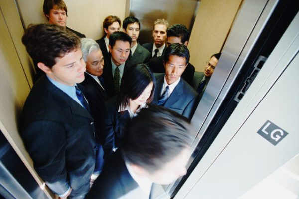 Businesspeople Exiting Elevator --- Image by © Tim Pannell/CORBIS