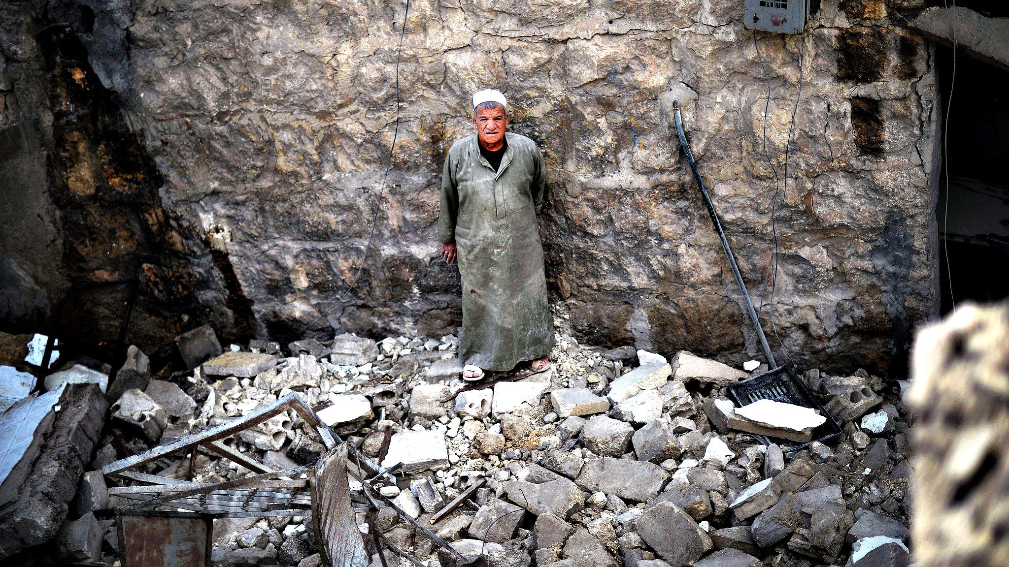 A man stands shocked in the remains of a...A man stands shocked in the remains of a house following an airstrike by the Syrian airforce in the northern Syrian city of Aleppo on April 15, 2013. The conflict in Syria, which is now in its third year, has cost 70,000 lives, according to the United Nations. AFP PHOTO / DIMITAR DILKOFFDIMITAR DILKOFF/AFP/Getty Images