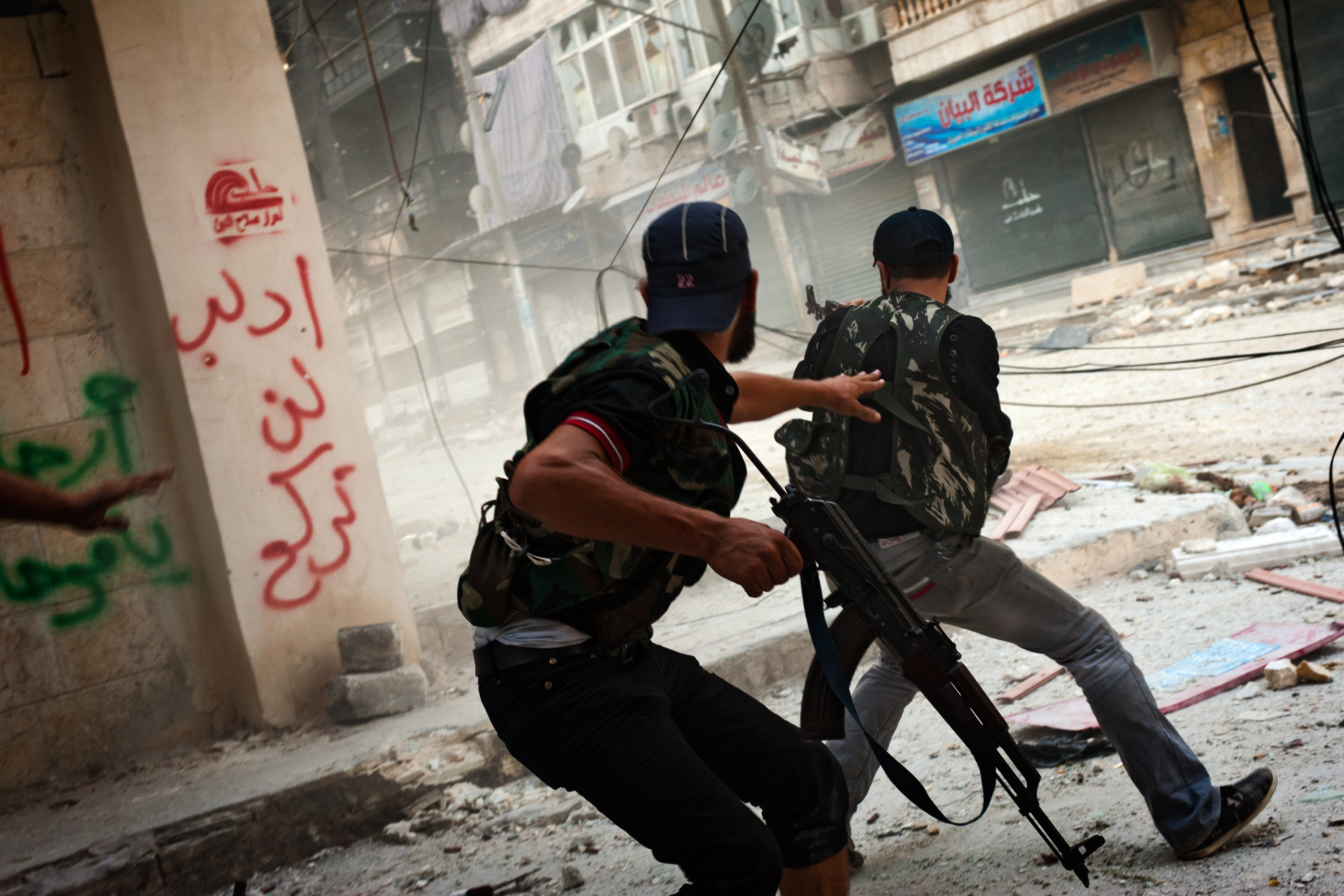 Free Syrian Army fighters exchange fire with regime forces in the Salah Al Din neighborhood of Aleppo, Aug. 22.
