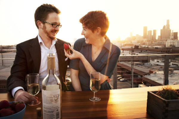 Couple on rooftop drinking wine