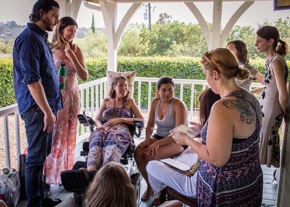 This July 24, 2016 photo provided by Niels Alpert, Betsy Davis, third from left, has a laugh with her friends during a going away party in Ojai, Calif. In early July, Davis emailed her closest friends and family to invite them to a two-day celebration, telling them: "These circumstances are unlike any party you have attended before, requiring emotional stamina, centeredness, and openness. And one rule: No crying."  The 41-year-old woman diagnosed with ALS held the party to say goodbye before becoming one of the first California residents to take life-ending drugs under a new law that gave such an option to the terminally ill. (Niels Alpert via AP)