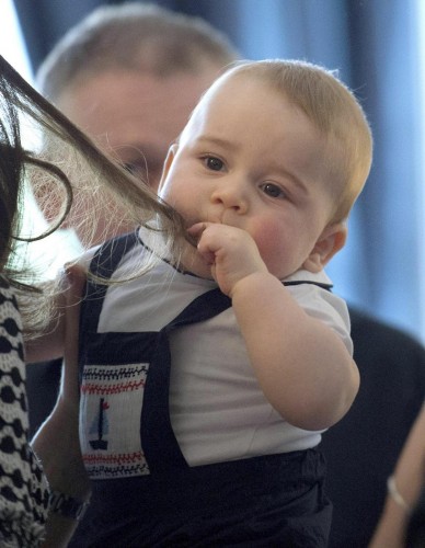 Britain's Prince George plays with the hair of his mother, Kate, the Duchess of Cambridge, during a visit to Plunket nurse and parents group at Government House in Wellington, New Zealand, Wednesday, April 9, 2014. Plunket is a national not-for-profit organization that provides care for children and families in New Zealand. Britain's Prince William, Kate and their son, Prince George, are on a three-week tour of New Zealand and Australia. (AP Photo/Marty Melville, Pool)